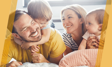 Family of four laughing together