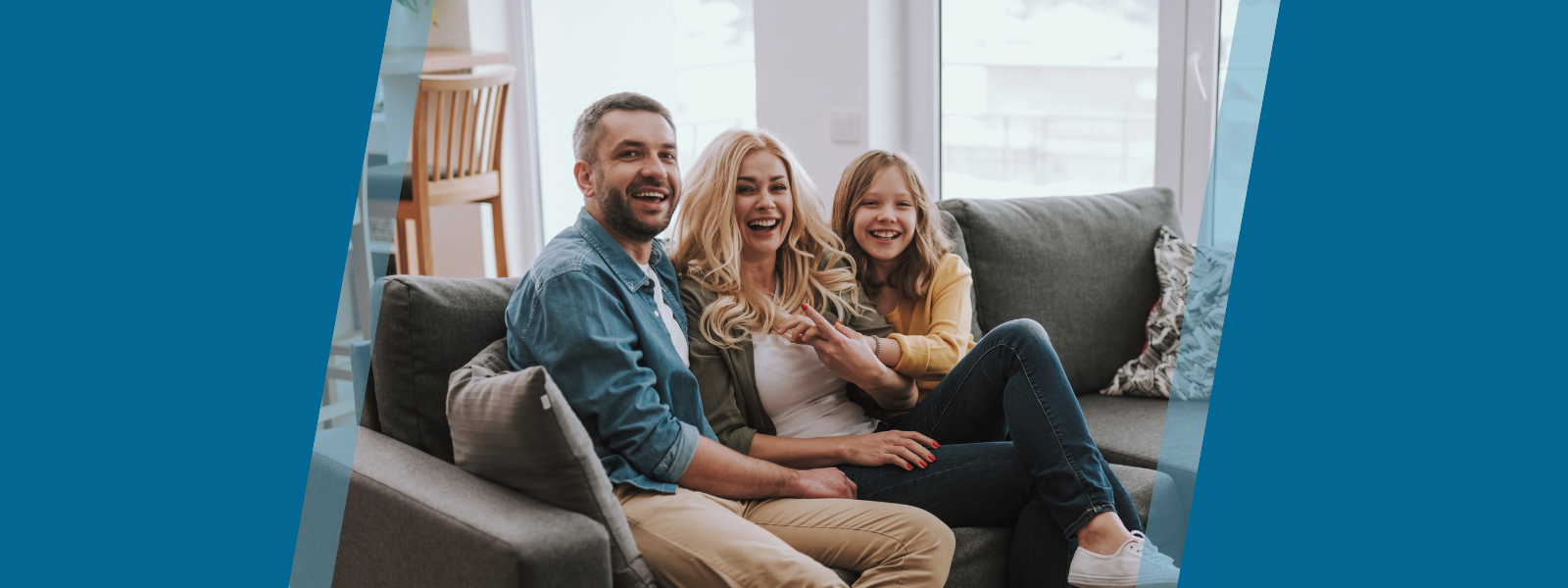 Happy family of three at home on the couch