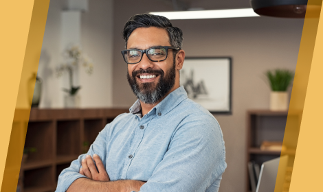 Business owner in office smiling at camera