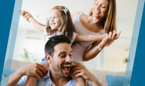 Family of three laughing at home