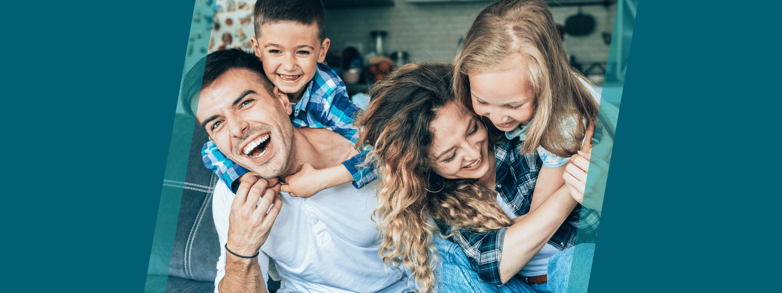 Family of four laughing together